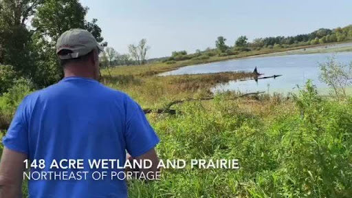 Image of Jeff Nania standing next to a wetland. Text reads 148 Acre Wetland and Prairie Northeast of Portage